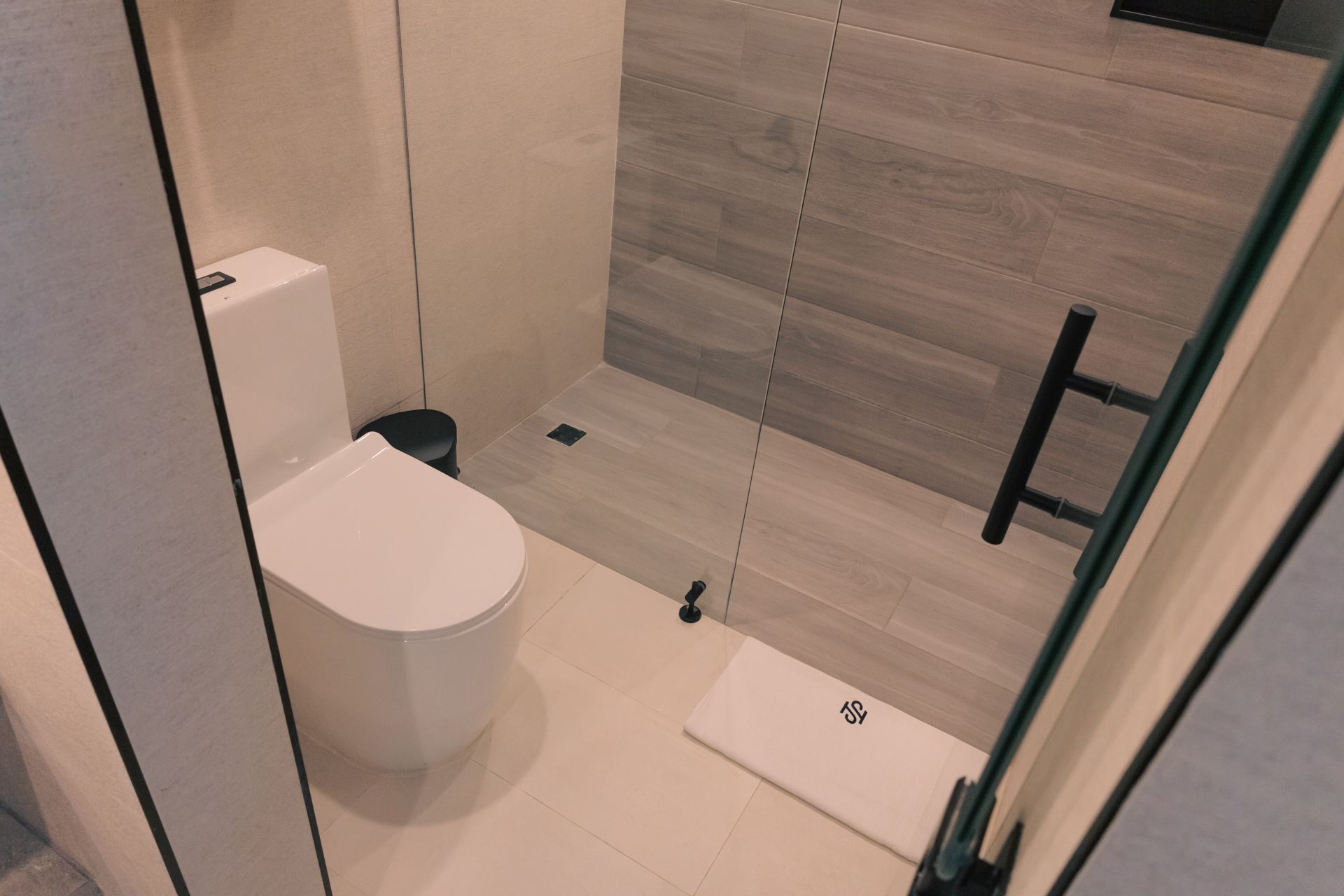 A bathroom with a toilet and a walk in shower.
