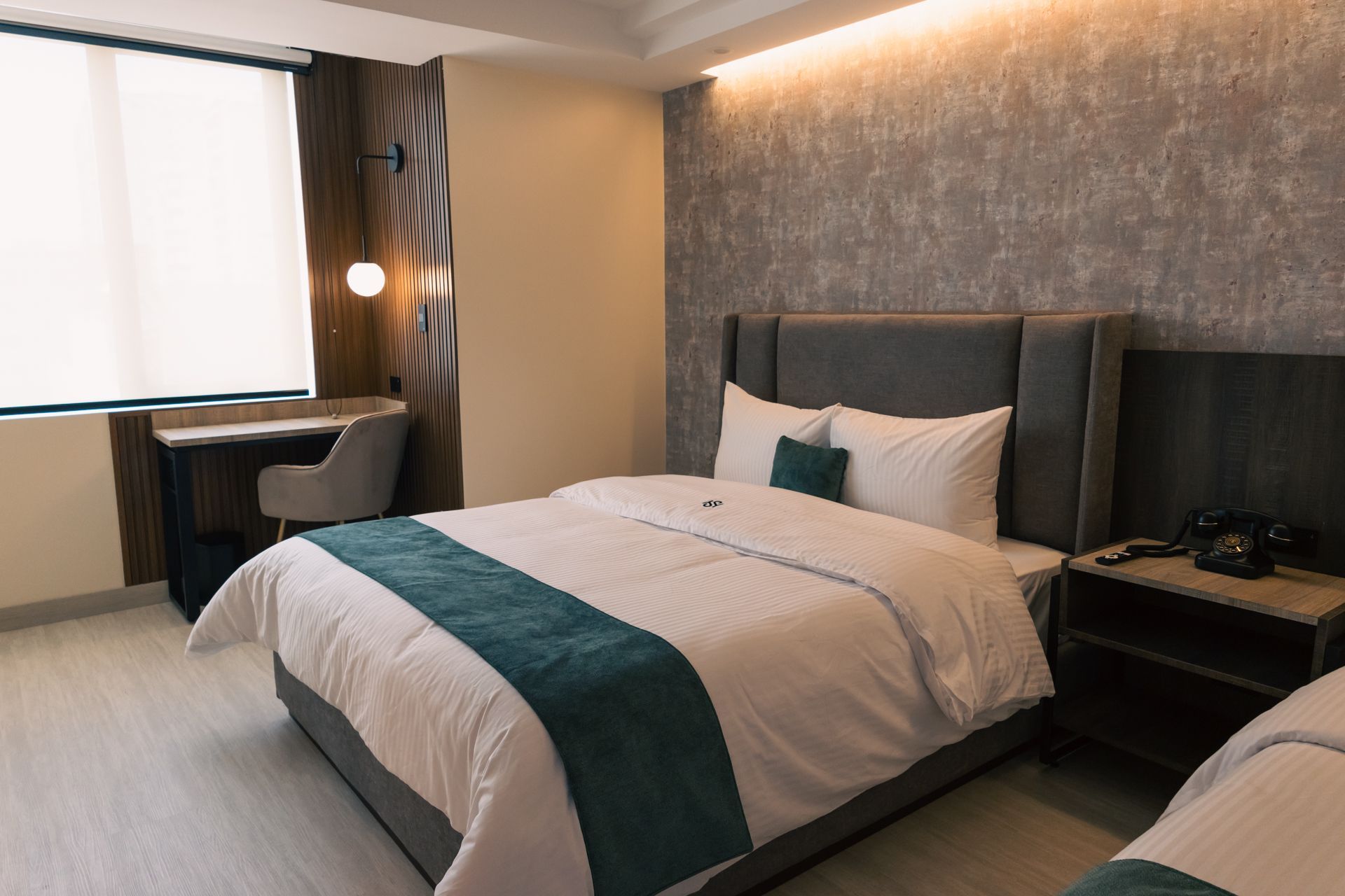 A hotel room with a king size bed and two twin beds.