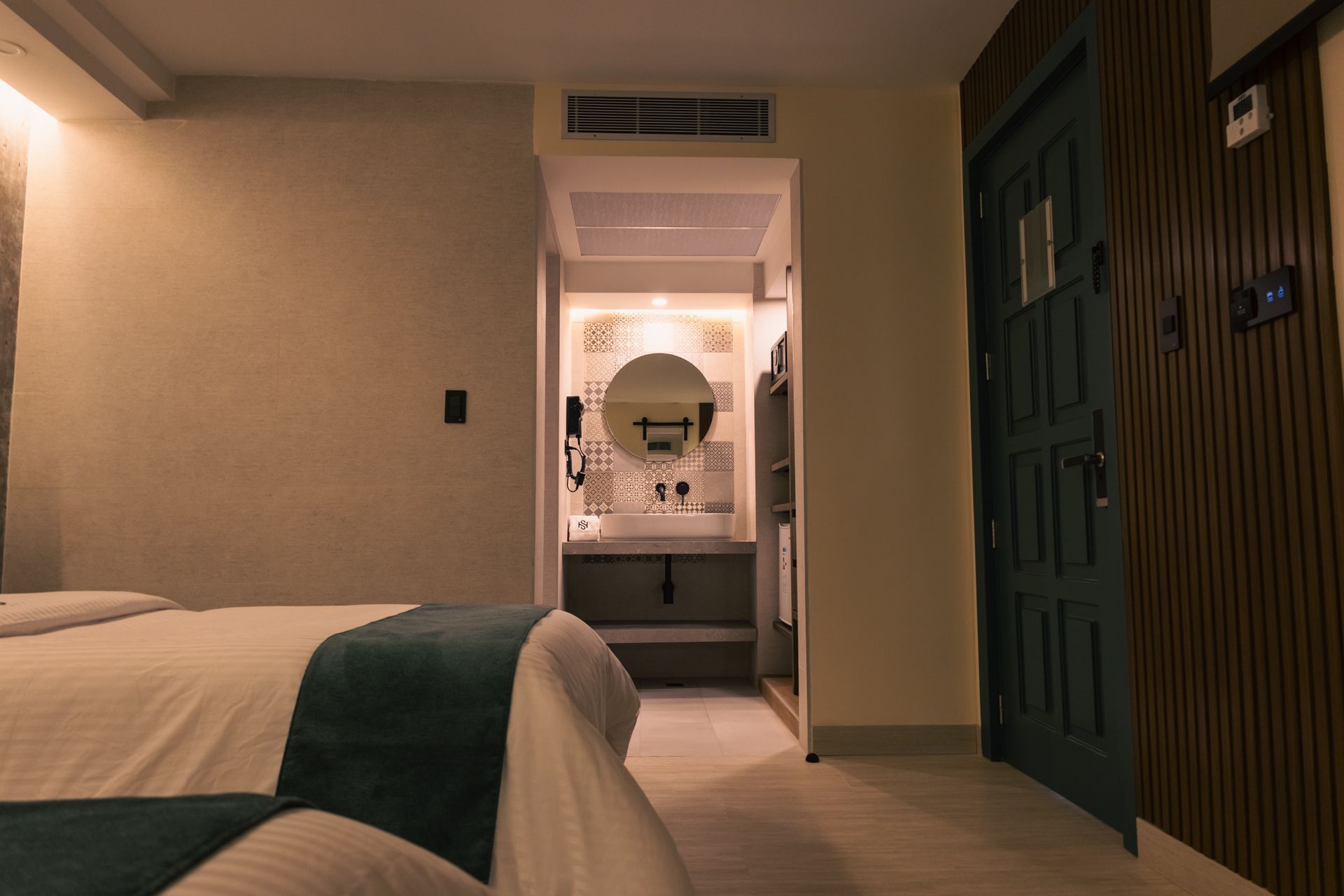 A hotel room with a bed and a bathroom.