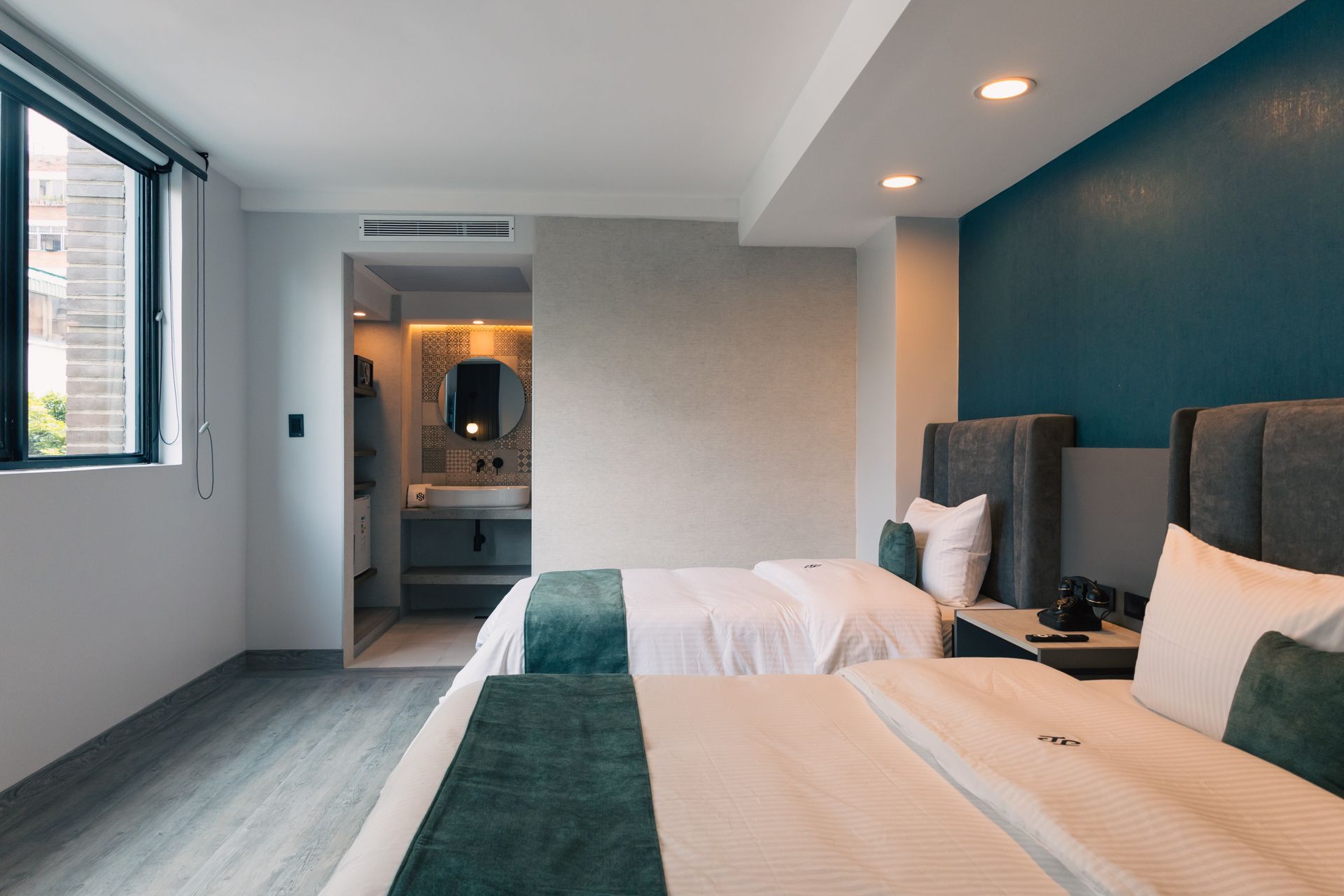 A hotel room with two beds and a window