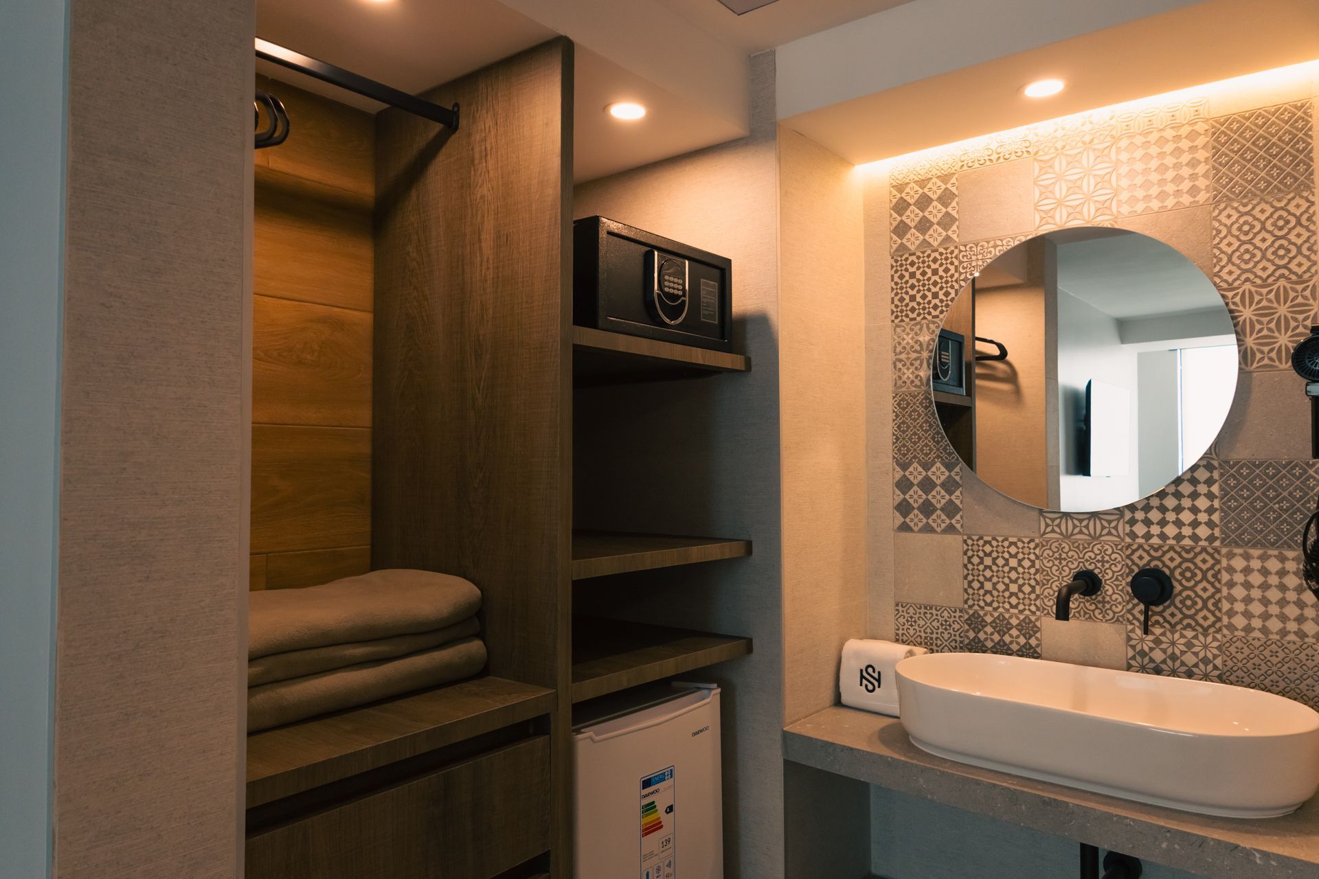 A bathroom with a sink , mirror and closet.