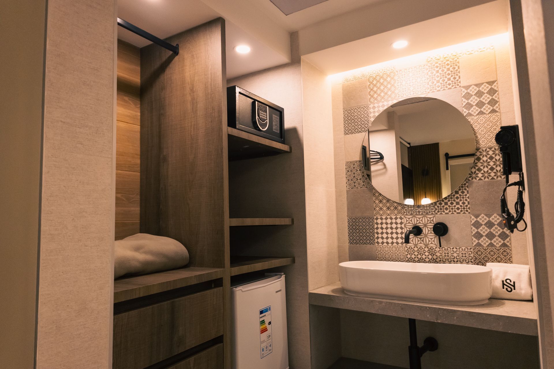 A bathroom with a sink , mirror and closet.