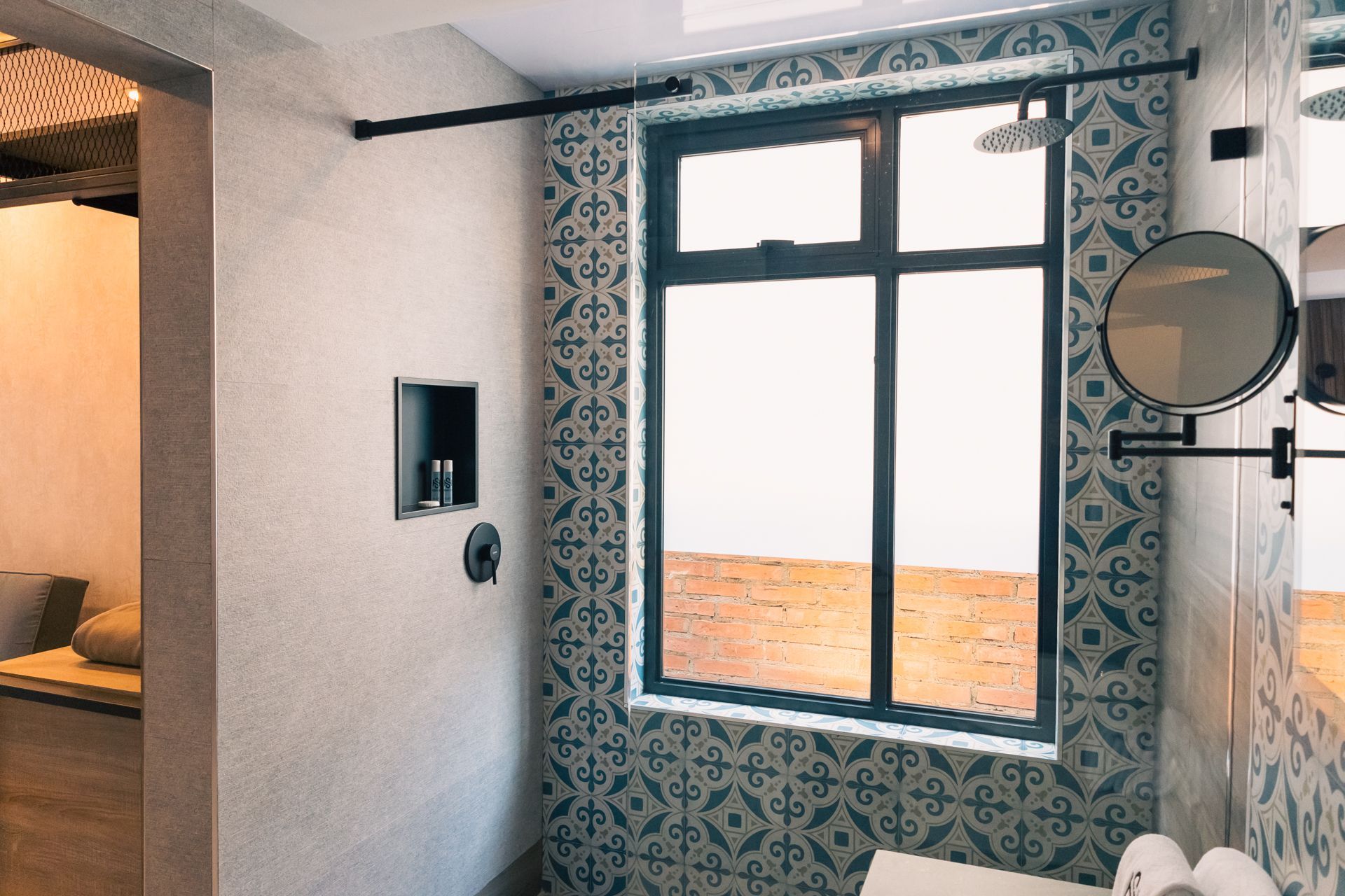 A bathroom with a large window and a mirror.