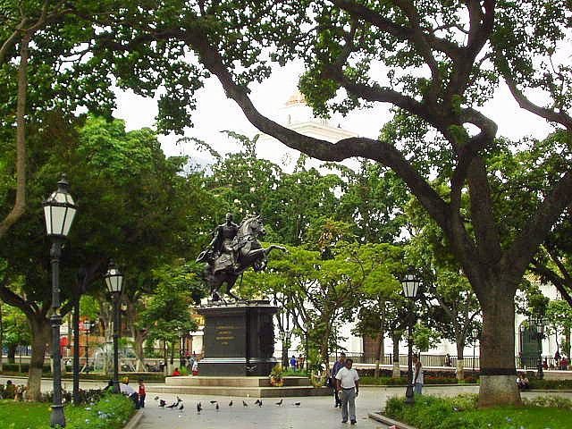 A statue of a man on a horse in a park