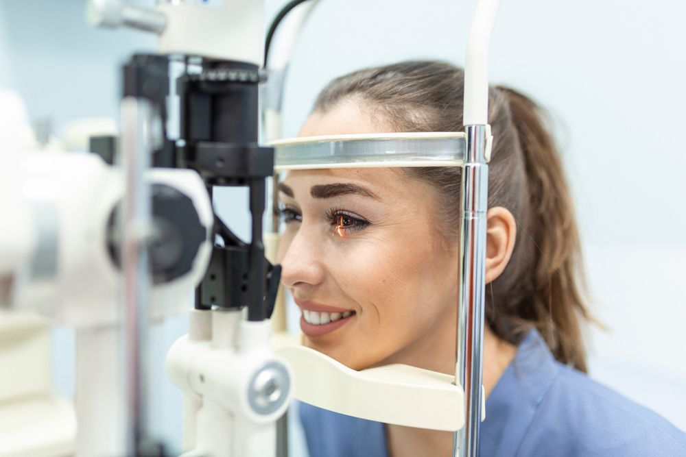 A woman is getting her eyes examined by an ophthalmologist
