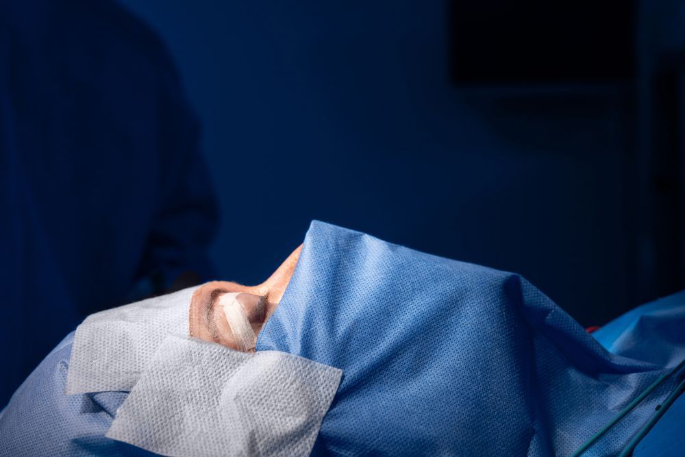 A surgeon is operating on a patient in an operating room