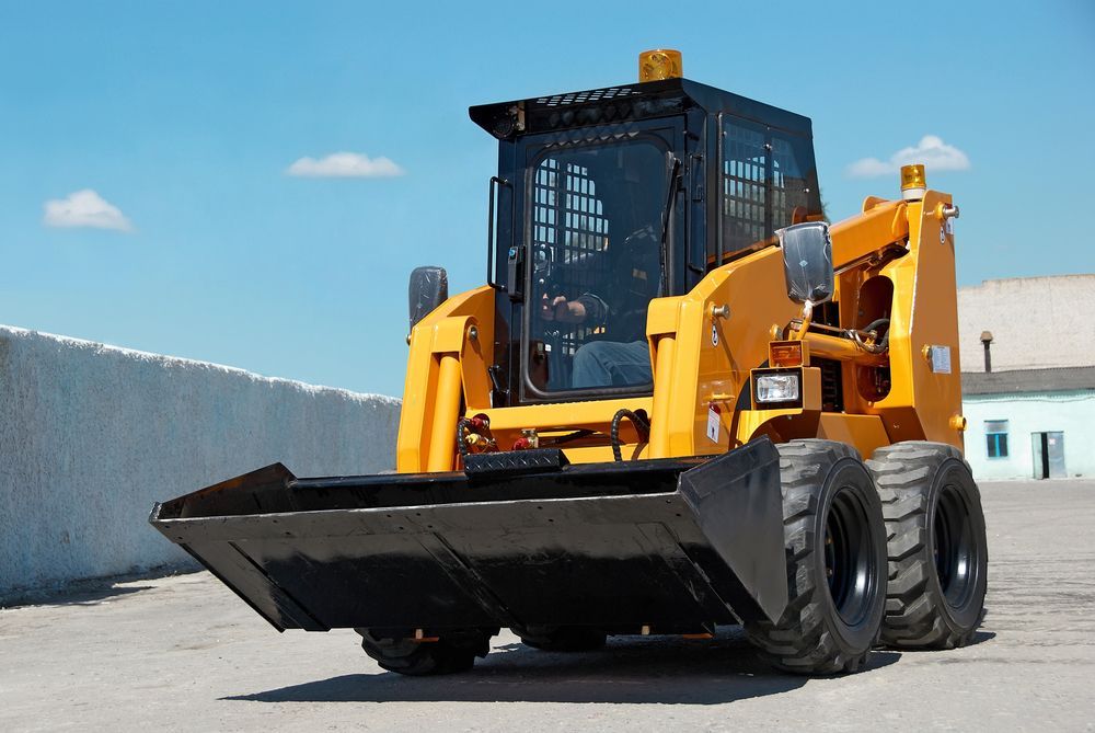 Yellow Skid Steer Loader With Black Bucket — Damon's Earthworks in Chatsworth, QLD