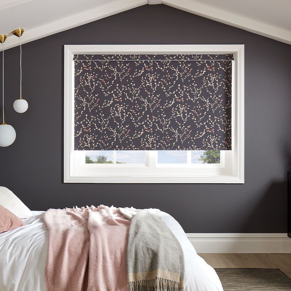 A bedroom with a bed and a window with a blind on it