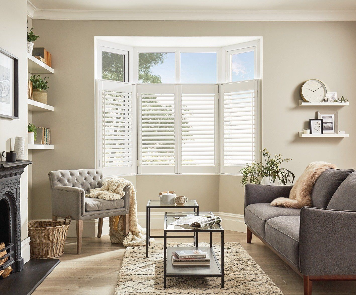 A living room with a couch , chair , coffee table and fireplace.