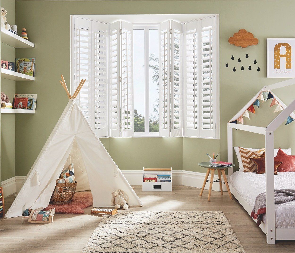 A child 's bedroom with a teepee and a bed.