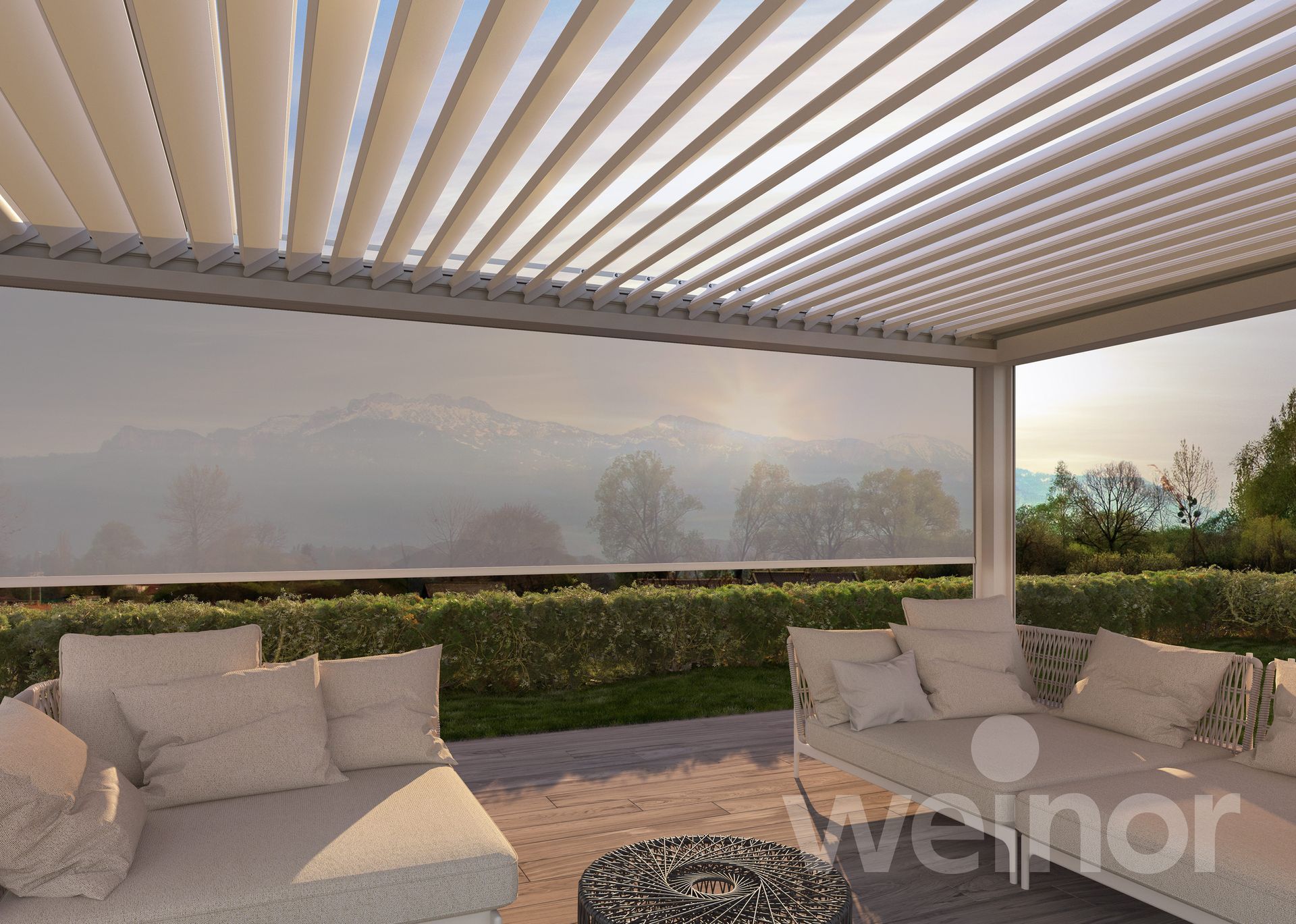 A patio with a couch and a table under a pergola that says weinor