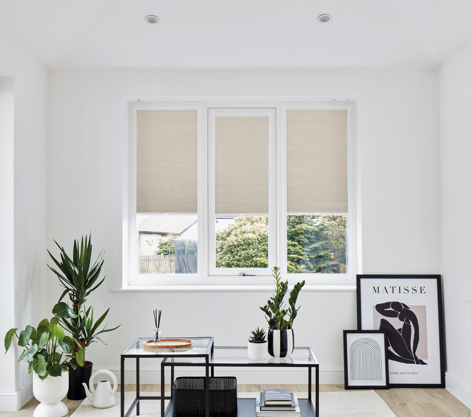 A living room with a table and a picture of matisse on the wall