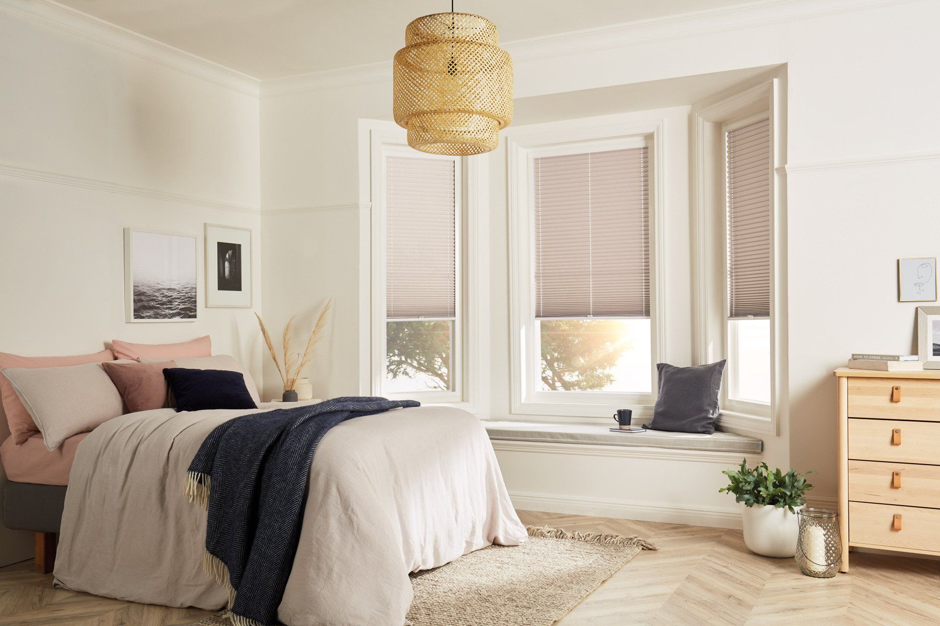 A bedroom with a bed , dresser , and window seat.