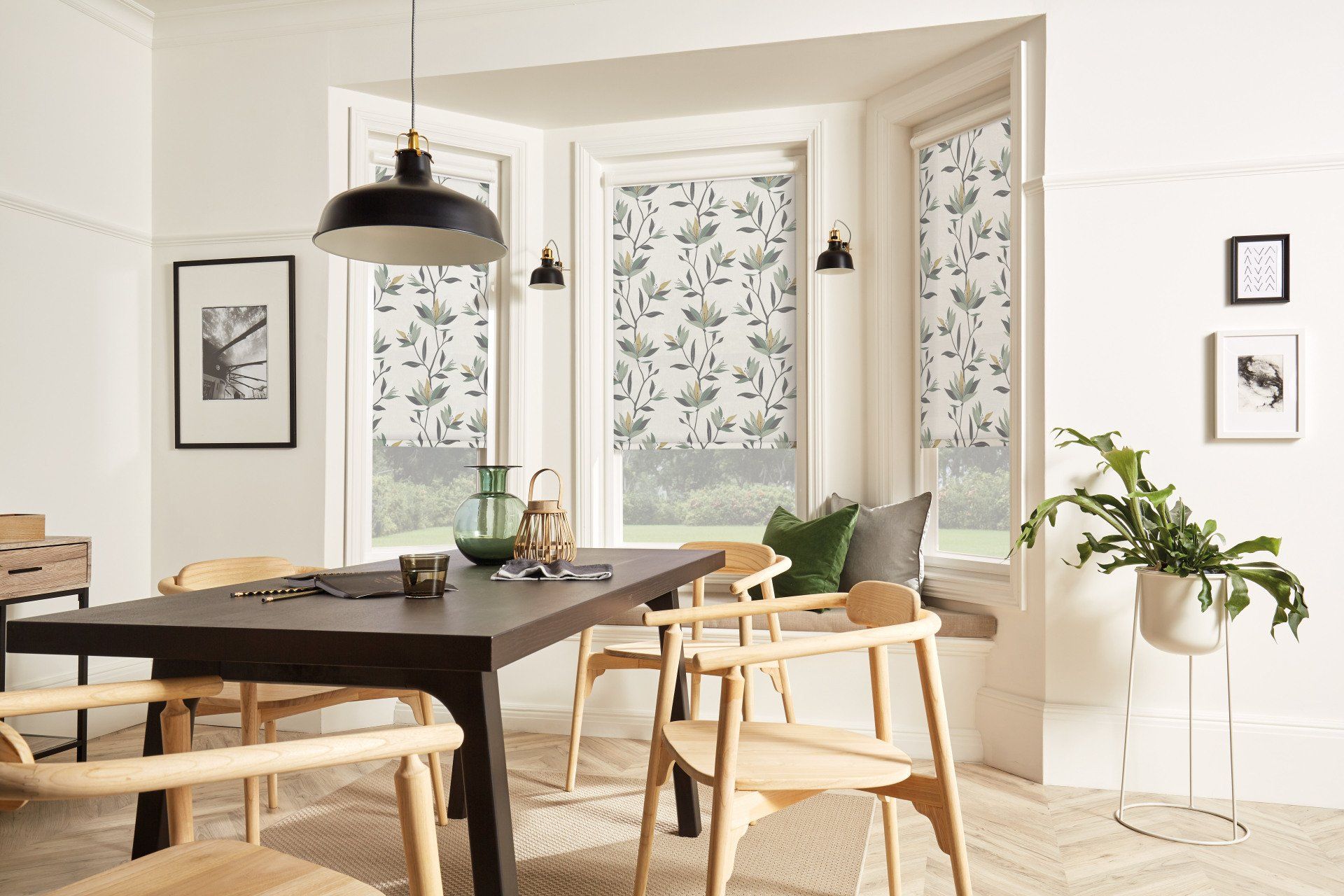 A dining room with a table and chairs and a window seat.