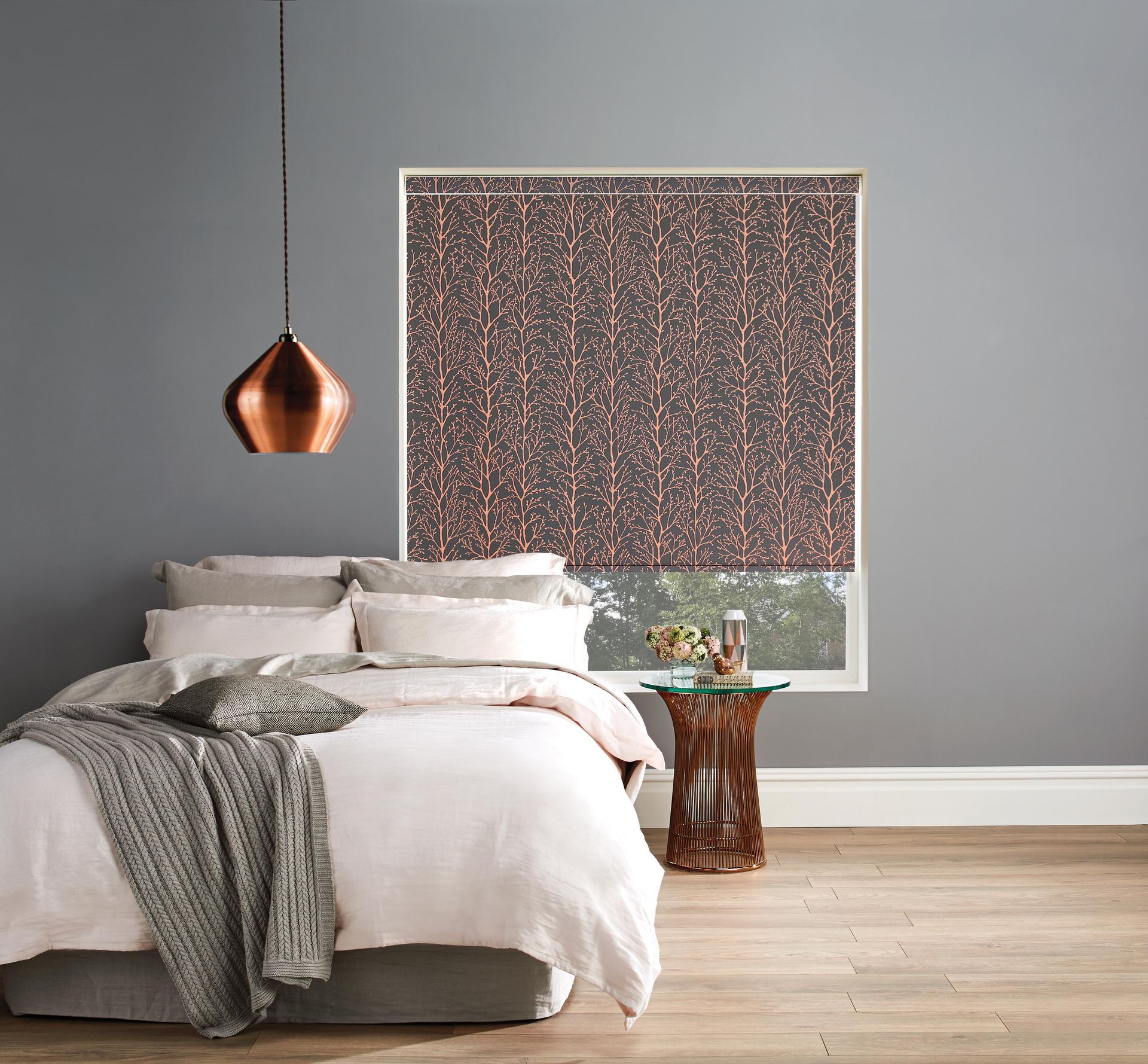 A bedroom with a bed and a window with a copper blind.