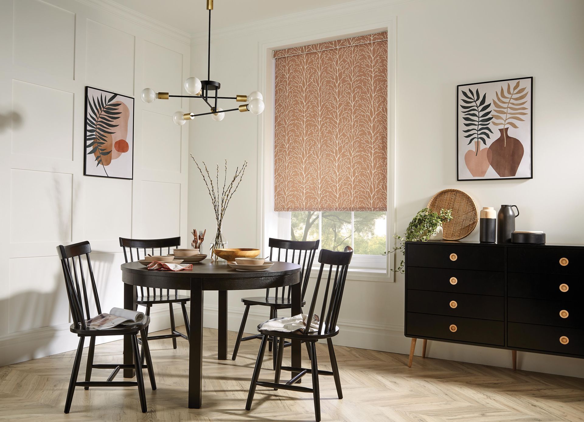 A dining room with a table and chairs and a dresser.