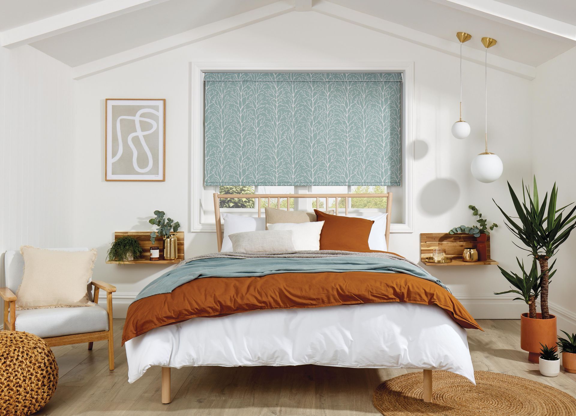 A bedroom with a bed , chair , plants and a window.