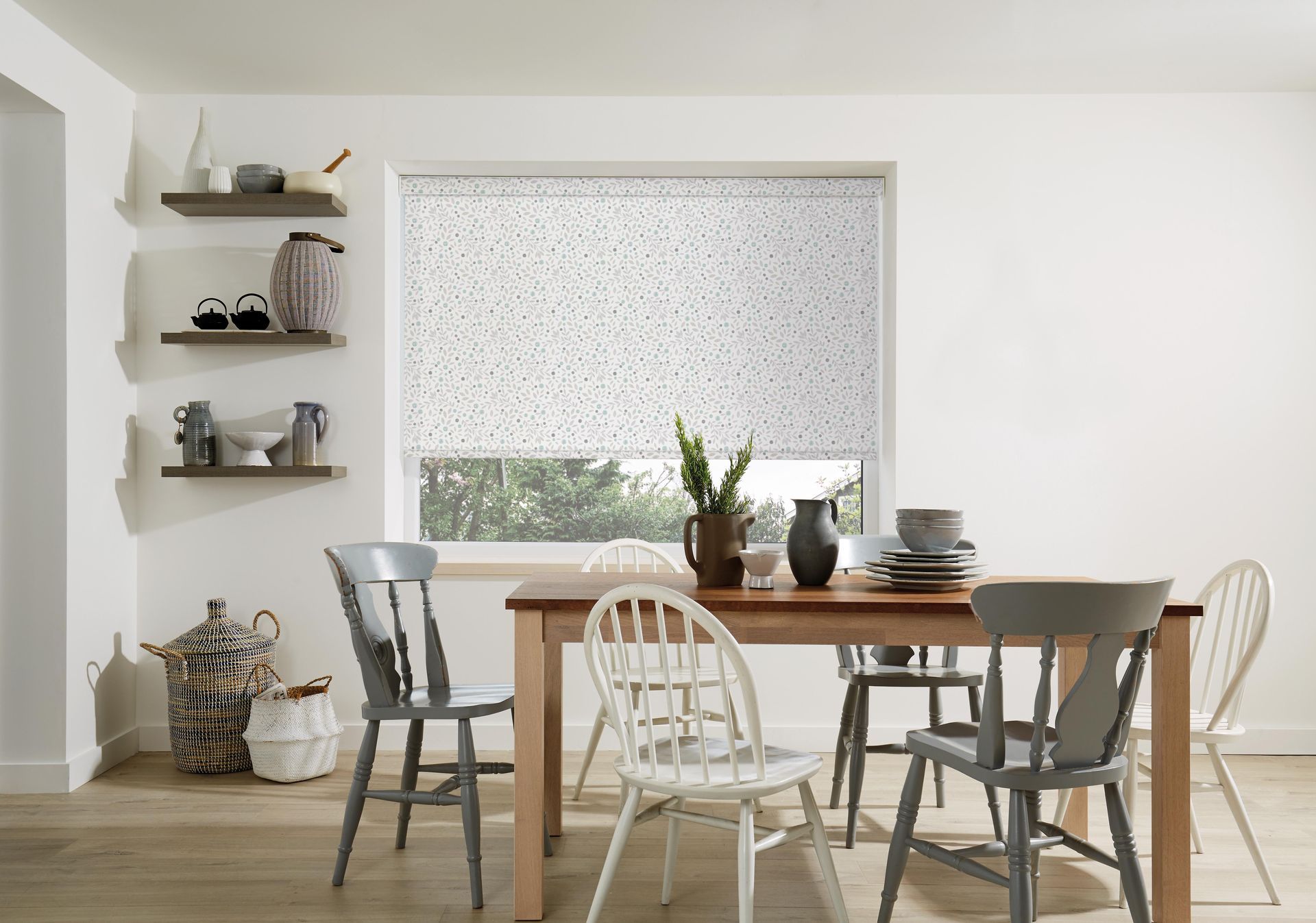 A dining room with a table and chairs and a window.