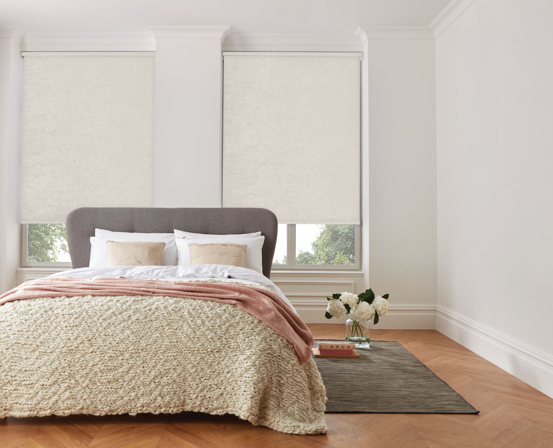 A bedroom with a bed and a window with blinds