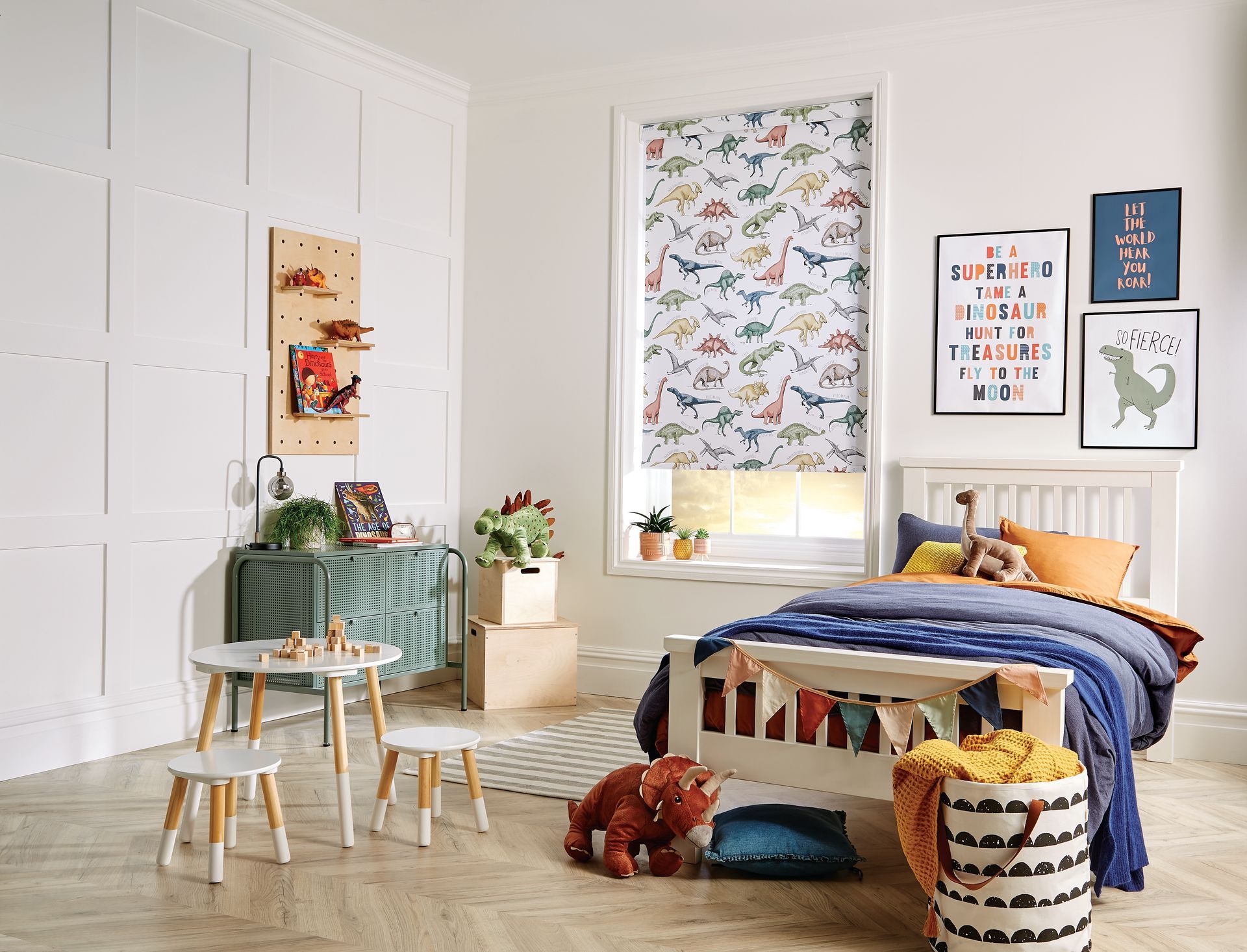 A child 's bedroom with a bed , tables and chairs.