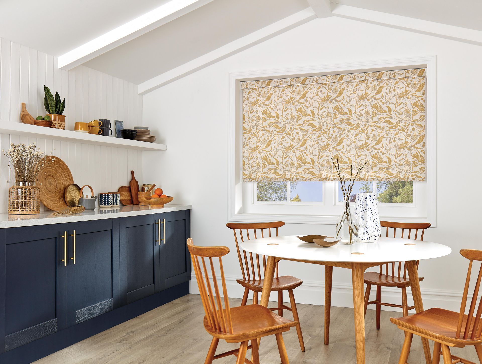 A kitchen with a table and chairs and a window.