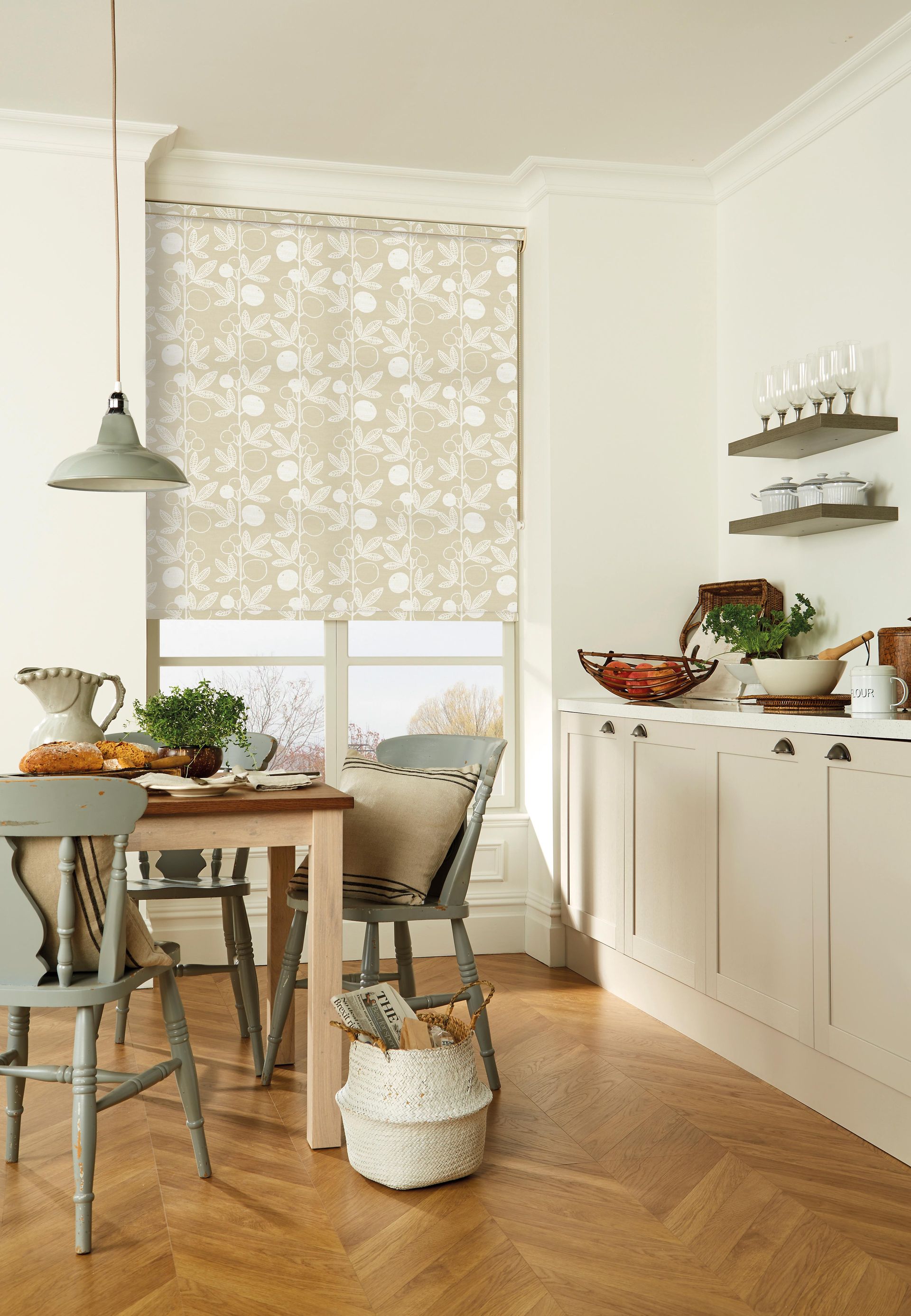 A kitchen with a table and chairs and a basket on the floor.