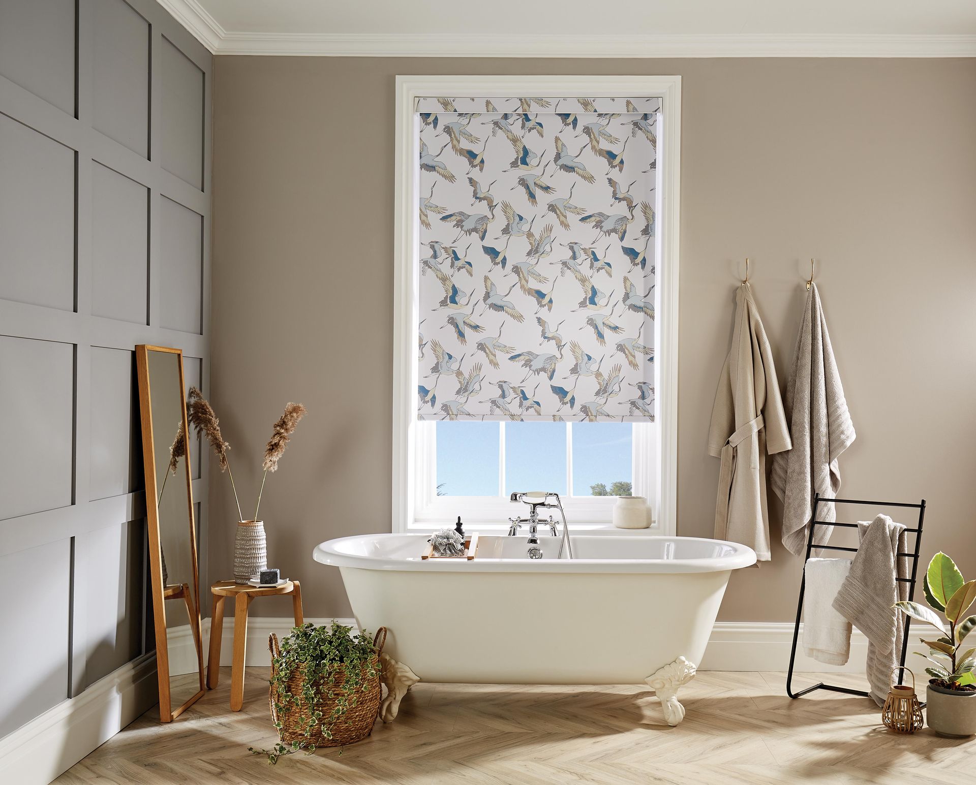 A bathroom with a bathtub and a window with a blind on it.