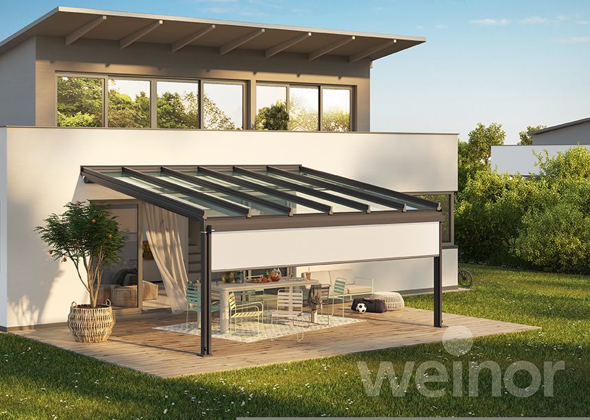 A white house with a pergola in front of it