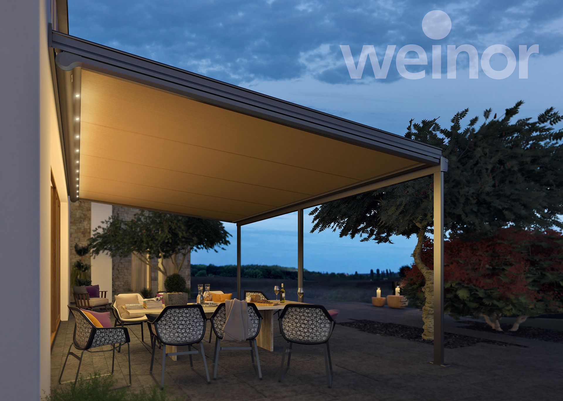 A patio with a table and chairs under a canopy.