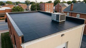 Freshly installed EPDM rubber membrane flat roof on a small commercial building in Pennsylvania.
