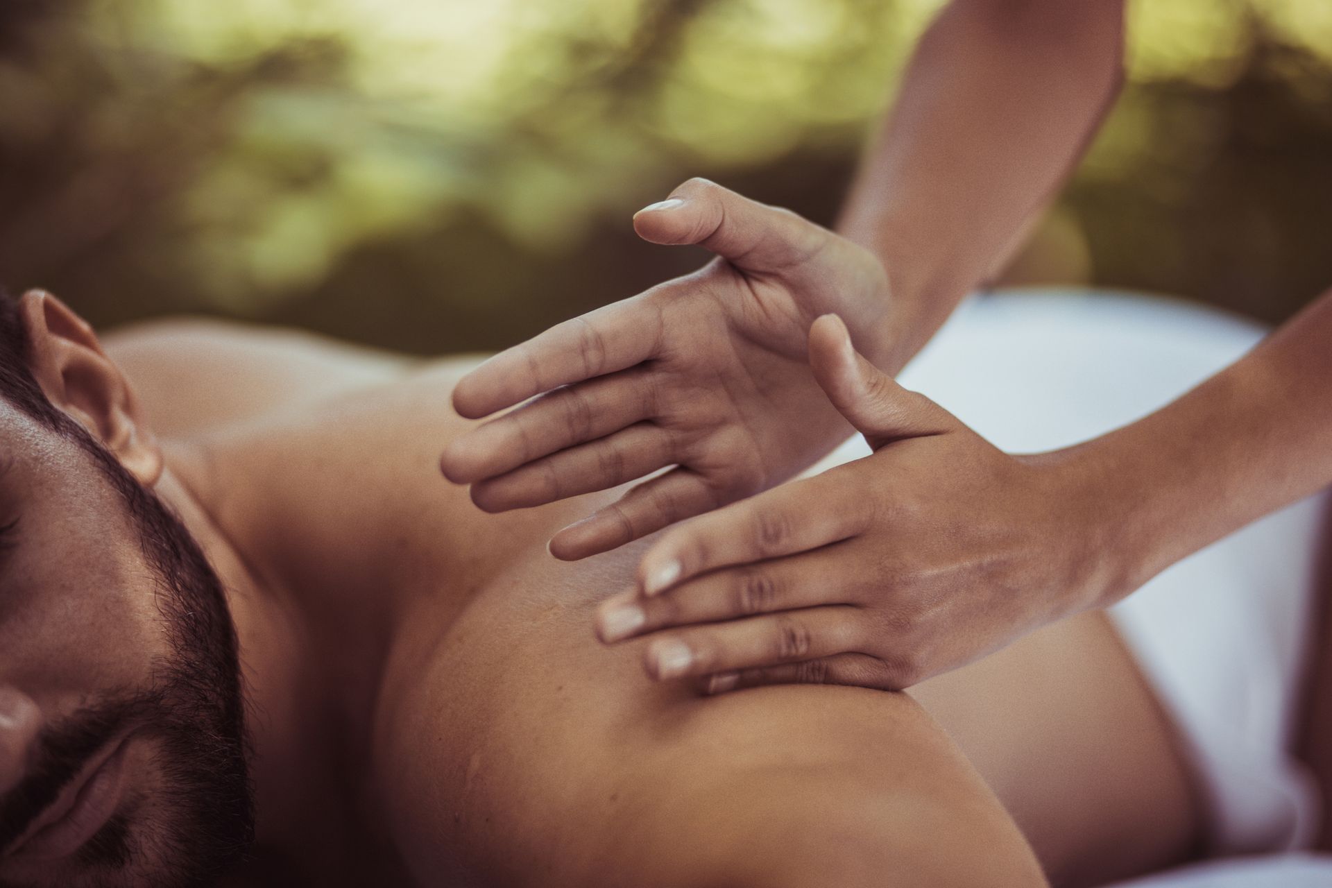 Men relaxing during treatment, showcasing cancer massage therapy for wellness benefits.