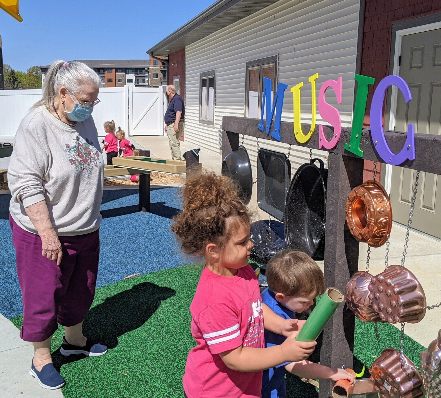 little girl and active senior lady playing in the outdoor classroom