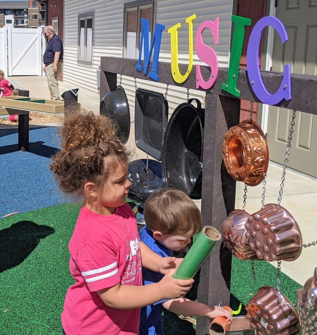 little girl and active senior lady playing in the outdoor classroom