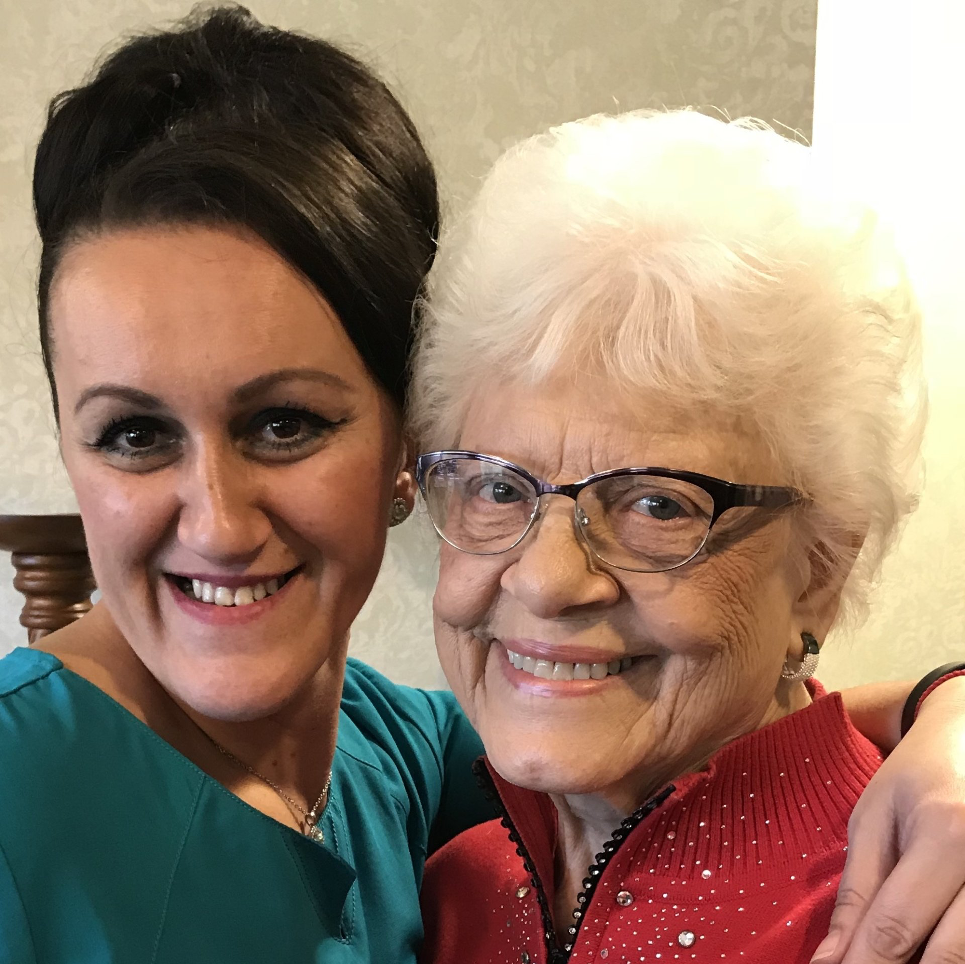 nurse with her arm around elderly resident