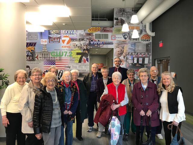 Group of active seniors posing at the KWWL news station group of seniors on a field trip to KWWL news station in Waterloo, Iowa
