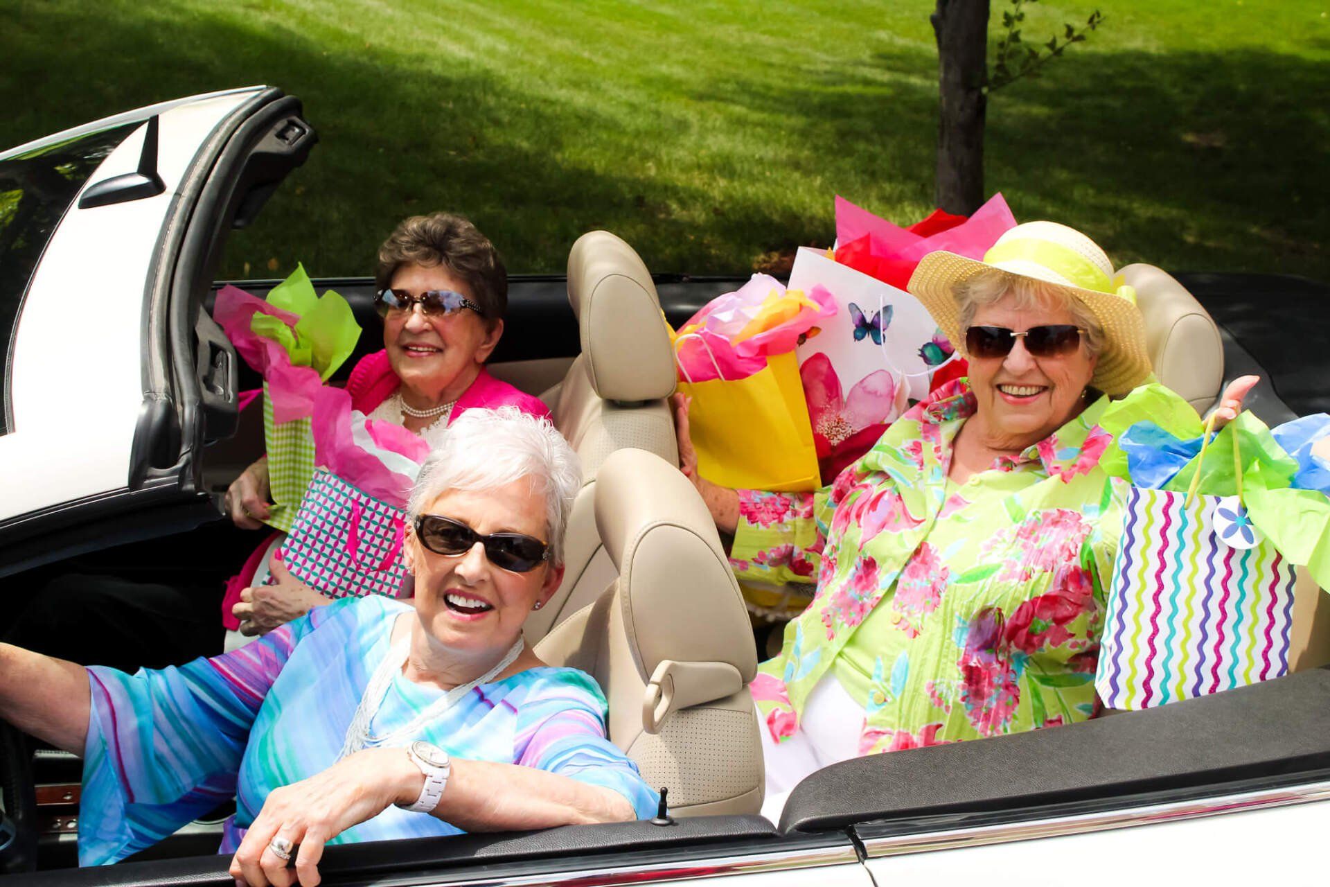 Three retired ladies out and about riding in a convertible active Friendship Village residents enjoying retirement riding around in a convertible