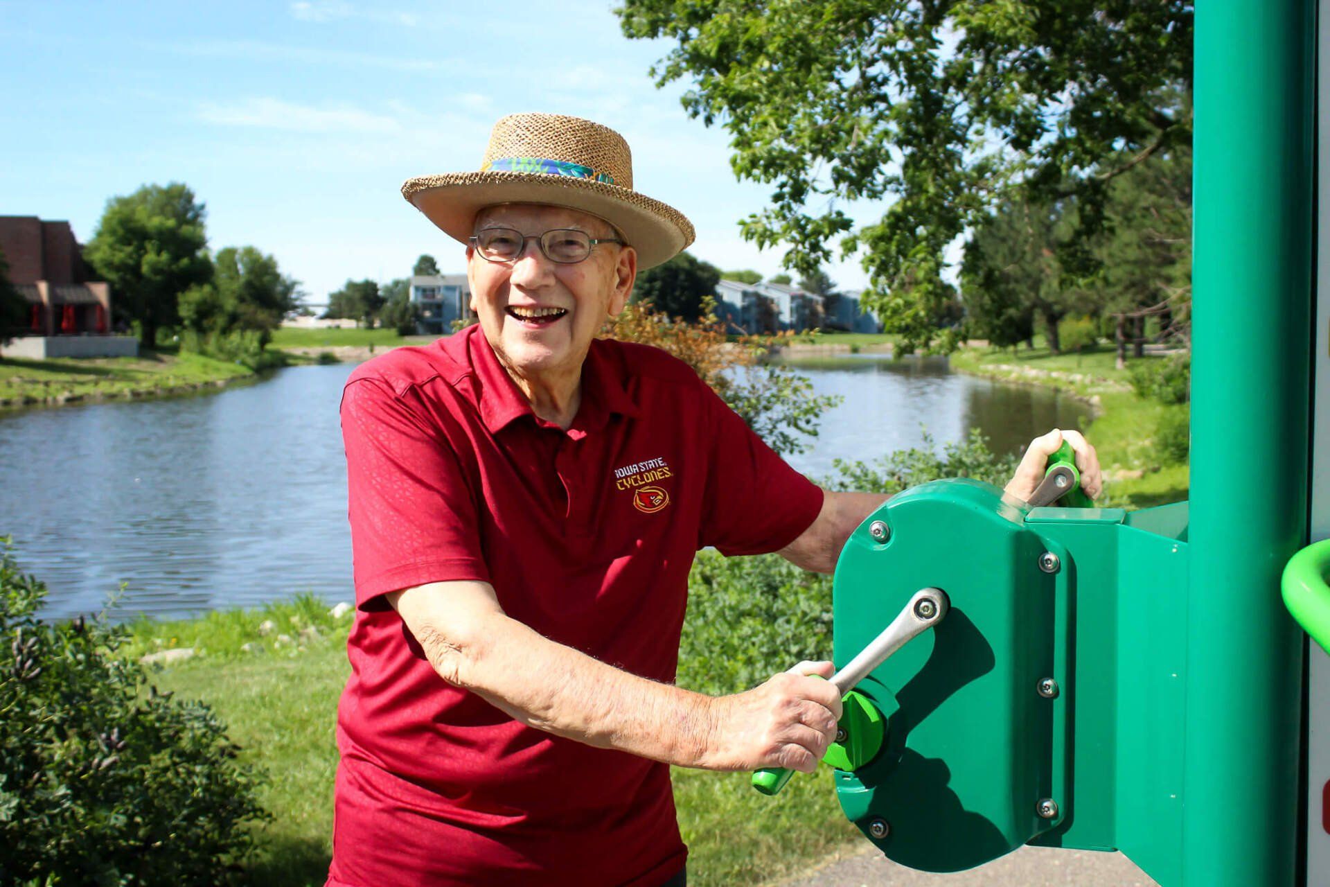 active senior living resident exercising on the donated green machines