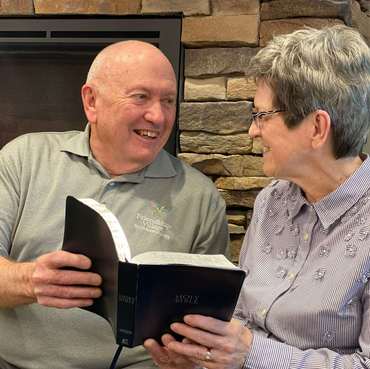 Retirement community Chaplain studying the Bible with his wife