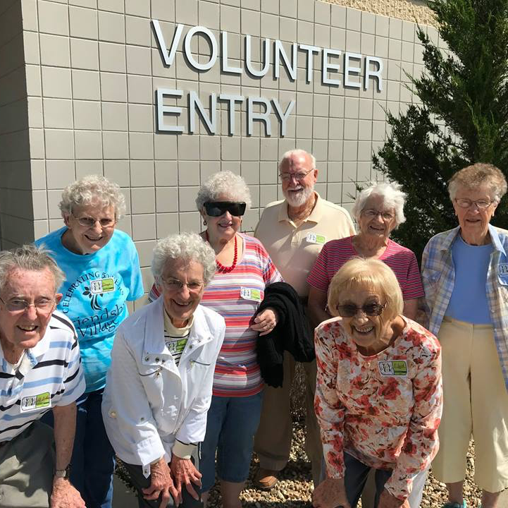 Volunteers posing outside the NEIA Food Bank