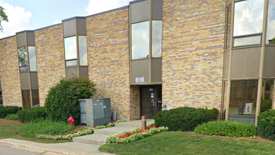 A large brick building with a fire hydrant in front of it.