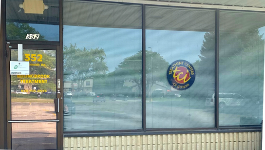 A picture of a store front with a sign on the window.