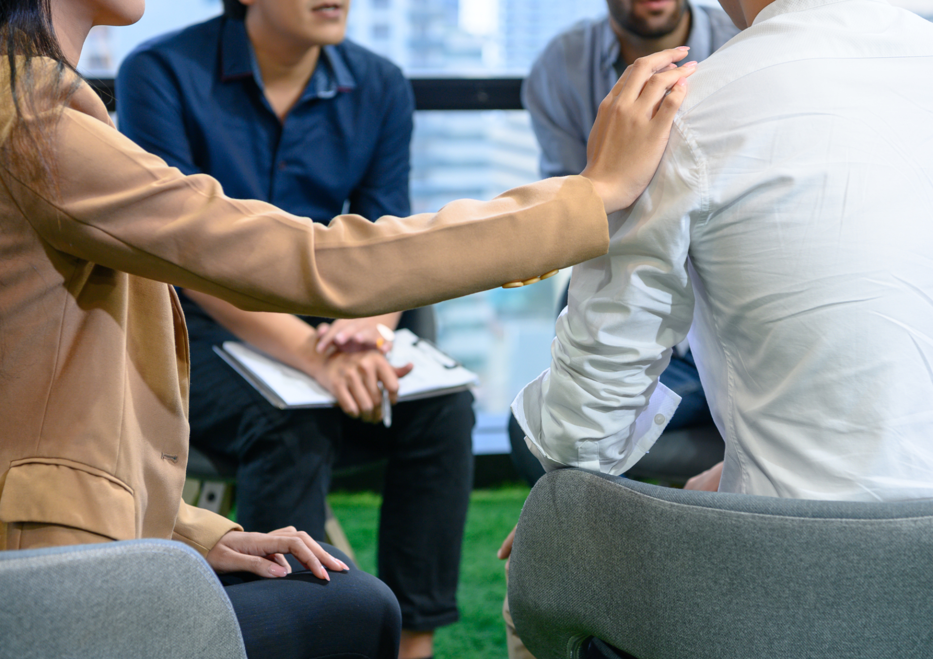 A group of people are sitting in a circle and talking to each other.