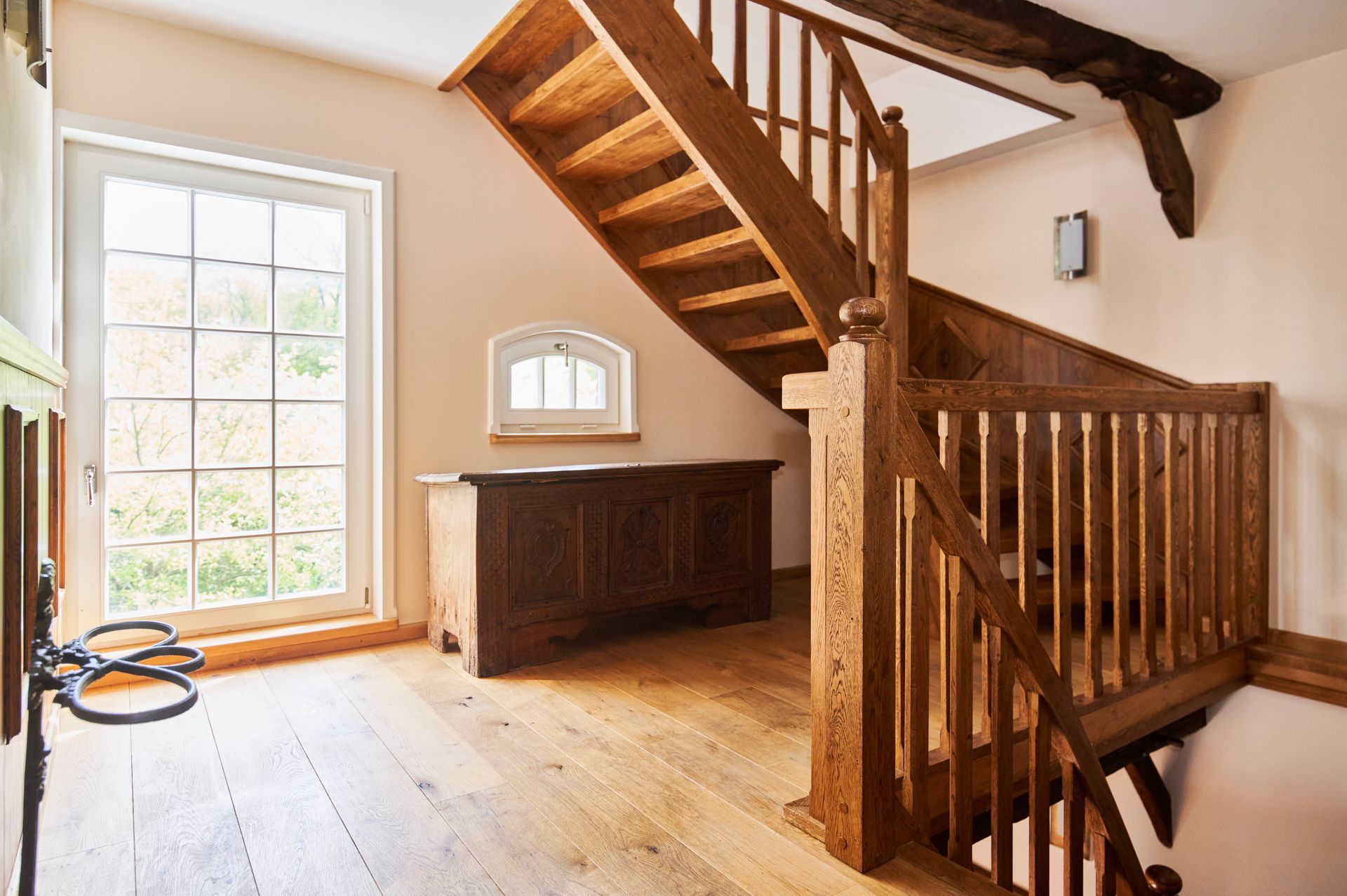 In der Mitte des Raumes befindet sich eine Holztreppe.