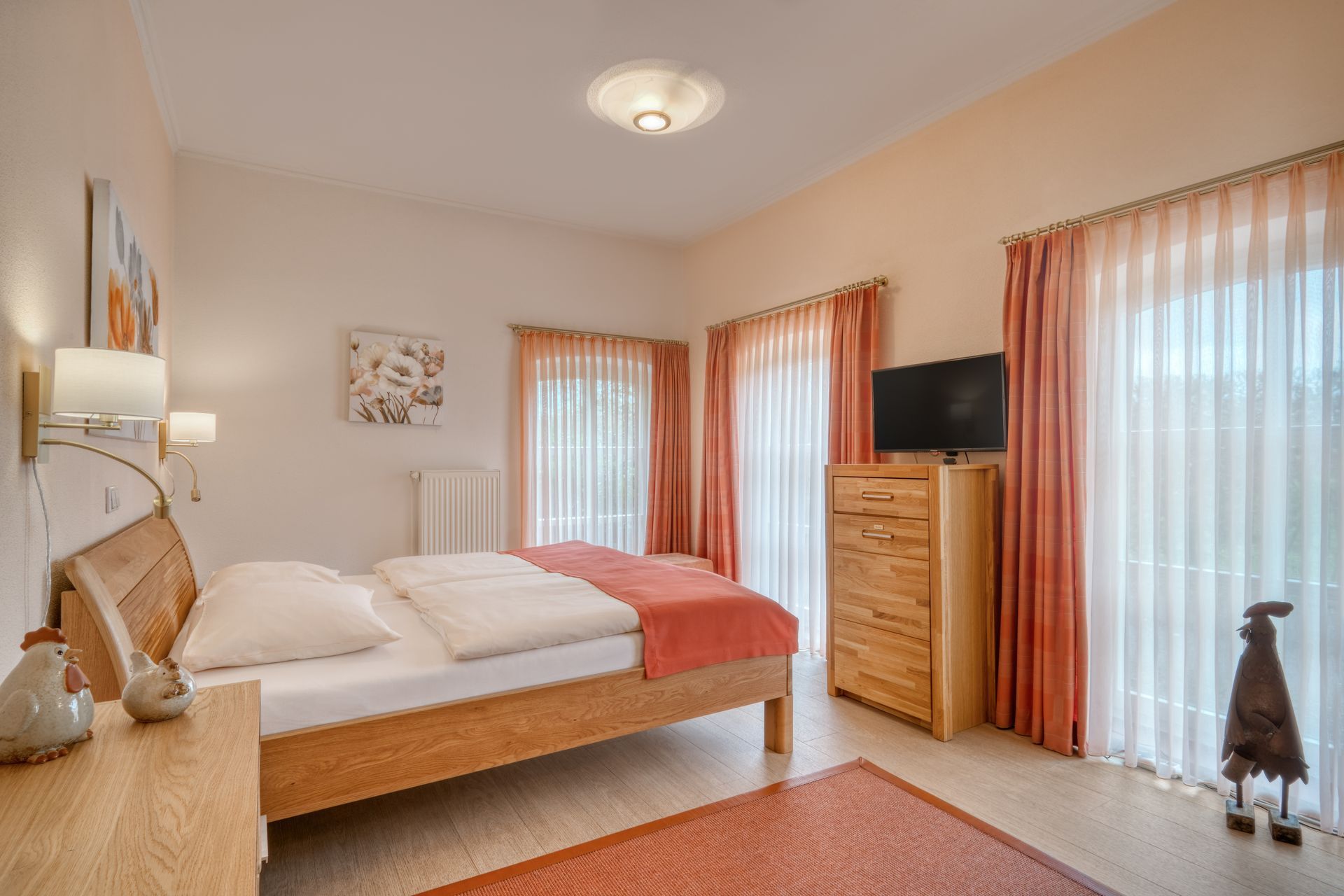 Ein Schlafzimmer mit Bett, Kommode und Fernseher.