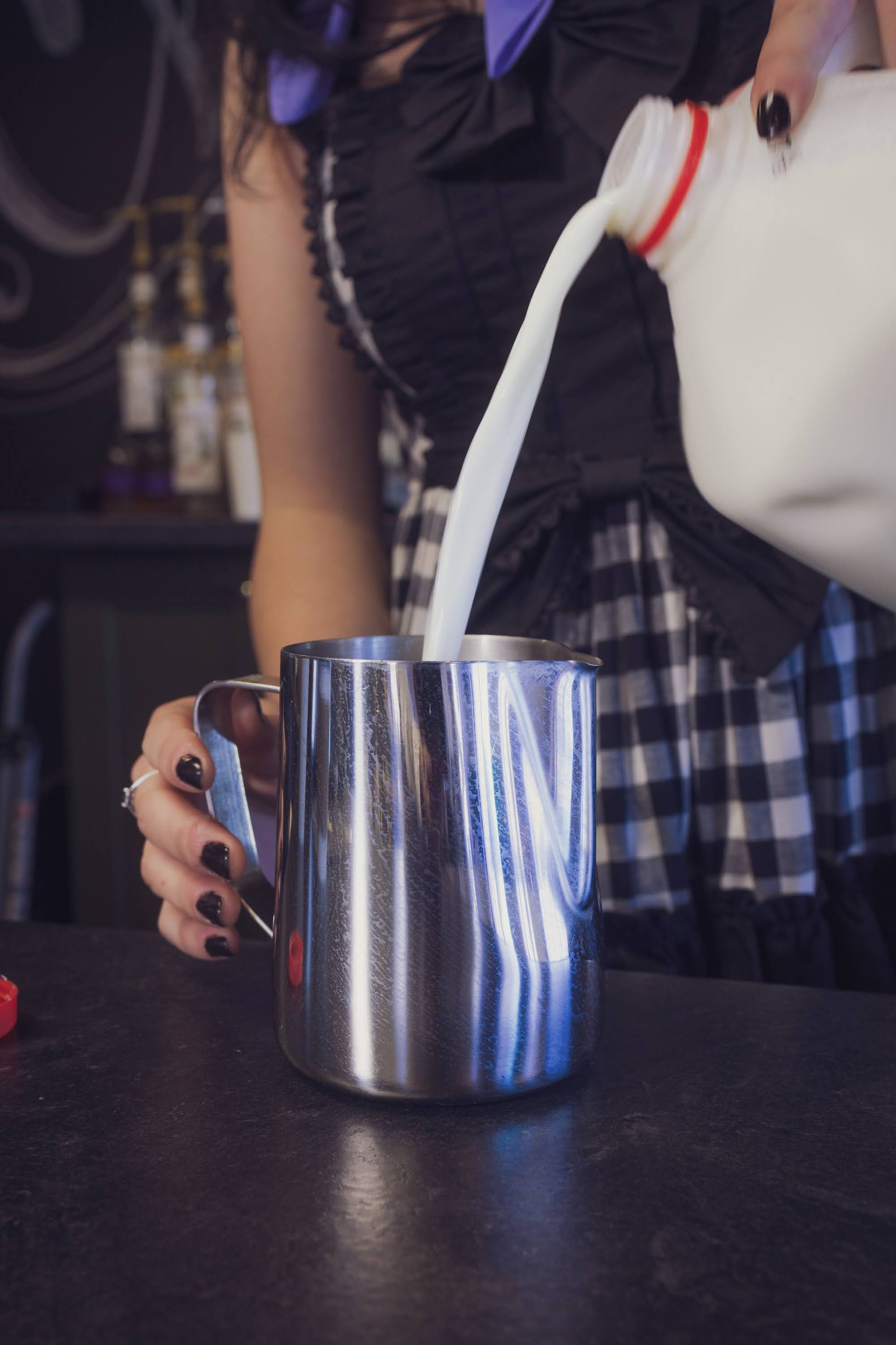 milk being poured into carafe 