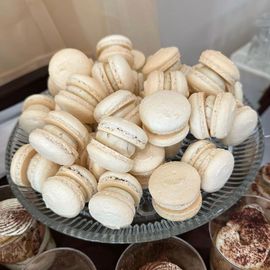 a plate of white macarons