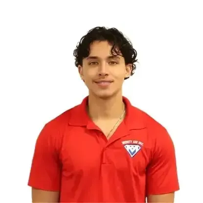 Young person in a red polo shirt with a logo, standing against a white background.