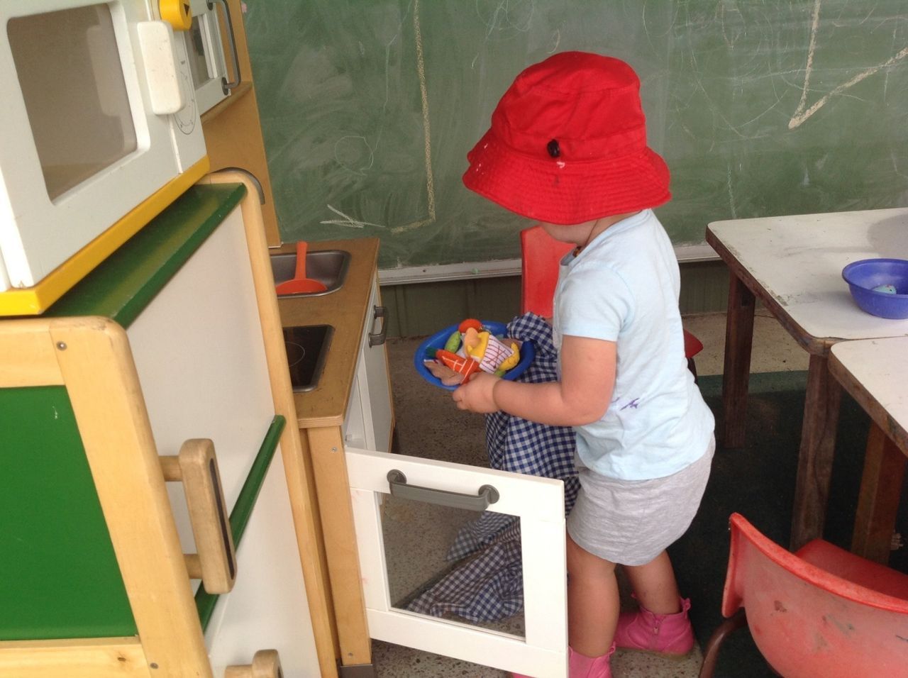 Little Girl Playing with Kitchen — Holmesville, NSW — Holmesville Playhouse Preschool