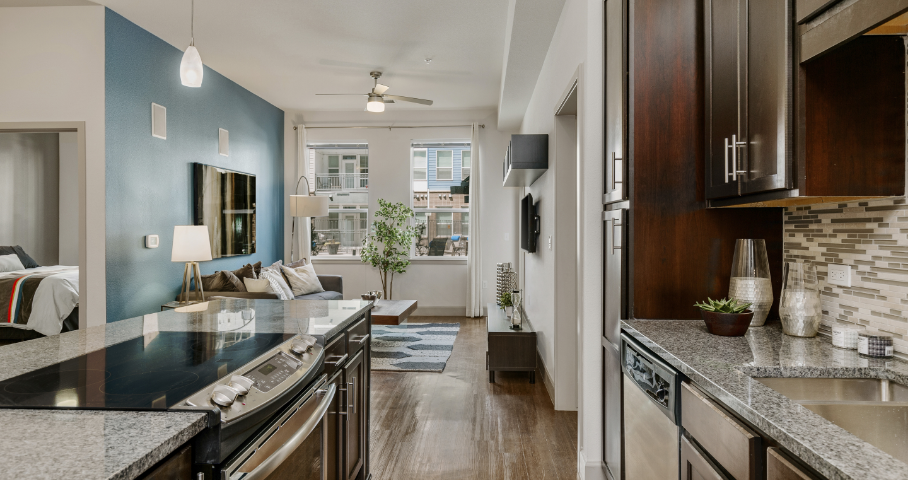 A kitchen with granite counter tops , stainless steel appliances , and a stove top oven.