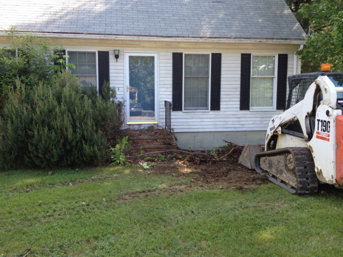Basement drainage system install with new landscaping in Westbrook Maine done by A.R. Cail